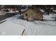 Overhead view of the back of a house with a small stoop entrance and snow-covered yard in a suburban neighborhood at 210 S West St, Paragon, IN 46166