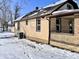 Exterior view of the house showing siding and snow covered ground at 210 S West St, Paragon, IN 46166