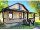 Attractive two-story home featuring a welcoming side porch, brick and siding, and well-maintained landscaping at 210 S West St, Paragon, IN 46166