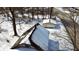 Birds-eye view of a house and detached garage covered in snow, surrounded by bare trees in a residential area at 210 S West St, Paragon, IN 46166