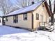 Side view of home with snow covered roof and yard at 210 S West St, Paragon, IN 46166