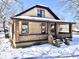 Home with a covered porch and siding in a neutral tone, situated in a winter landscape at 210 S West St, Paragon, IN 46166