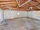 Spacious garage interior featuring unfinished walls and ceiling and a concrete floor at 210 S West St, Paragon, IN 46166