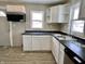 Updated kitchen with a new stainless-steel sink and black countertops at 210 S West St, Paragon, IN 46166