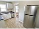 Well-lit kitchen area includes stainless steel refrigerator and ample countertop space at 210 S West St, Paragon, IN 46166
