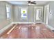 Hardwood floors in a gray-painted living room with natural light and ceiling fan at 210 S West St, Paragon, IN 46166
