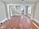 Living room with a view of the staircase and kitchen, offering an open layout with natural light at 210 S West St, Paragon, IN 46166