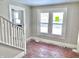 Living room with hardwood floors, natural light, and a view of the staircase and kitchen at 210 S West St, Paragon, IN 46166