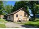 Cozy home with a white back door, complimented by well-maintained siding and a paved driveway at 210 S West St, Paragon, IN 46166