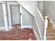 View of a staircase, door, and hardwood floors, showcasing the home's layout at 210 S West St, Paragon, IN 46166