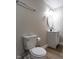 Bathroom with new toilet, vanity, hardware, and round mirror at 2162 Ringgold Ave, Indianapolis, IN 46203