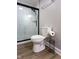 Bathroom featuring a new toilet and a subway tile shower with dark trim at 2162 Ringgold Ave, Indianapolis, IN 46203