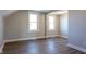 Bright bedroom with modern flooring, base trim, and two large windows for natural light at 2162 Ringgold Ave, Indianapolis, IN 46203