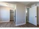 Bedroom with wood floors, fresh paint, walk-in closet, and white base trim at 2162 Ringgold Ave, Indianapolis, IN 46203