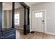 Welcoming foyer with striking dark wood accents, neutral walls and a bright white door at 2162 Ringgold Ave, Indianapolis, IN 46203