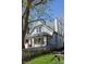 Beautiful two-story house with a charming front porch, surrounded by mature trees and greenery at 2162 Ringgold Ave, Indianapolis, IN 46203