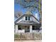 Inviting two-story home featuring a classic design, complemented by lush green landscaping at 2162 Ringgold Ave, Indianapolis, IN 46203