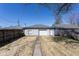 A detached one-car garage with a concrete walkway is surrounded by fenced yard at 2162 Ringgold Ave, Indianapolis, IN 46203