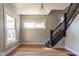 Inviting living room features wood floors, multiple windows, and elegant staircase at 2162 Ringgold Ave, Indianapolis, IN 46203