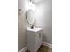 Bathroom vanity with new faucet, hardware, and round mirror at 2162 Ringgold Ave, Indianapolis, IN 46203