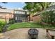 A backyard featuring a firepit, pergola, and a well-maintained lawn, adding charm to the outdoor space at 219 Buckingham Dr, Indianapolis, IN 46208