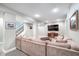 Finished basement featuring a large sectional couch, mounted TV and staircase at 219 Buckingham Dr, Indianapolis, IN 46208