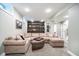 Spacious finished basement featuring a large sectional couch and built-in shelving at 219 Buckingham Dr, Indianapolis, IN 46208