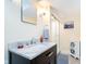 Bathroom featuring a marble countertop, vanity, mirror, towel rack, and shower at 219 Buckingham Dr, Indianapolis, IN 46208