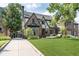 Beautiful brick home featuring a long driveway and an inviting front lawn at 219 Buckingham Dr, Indianapolis, IN 46208