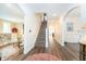 Spacious hallway featuring hardwood floors and staircase leading to upper level at 219 Buckingham Dr, Indianapolis, IN 46208