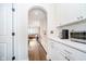 Hallway with white cabinets and countertops leads to a cozy living area at 219 Buckingham Dr, Indianapolis, IN 46208