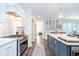 Modern kitchen with stainless steel appliances, center island, and white cabinetry and tiled backsplash at 219 Buckingham Dr, Indianapolis, IN 46208
