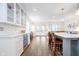 Open-concept kitchen with large center island, stainless steel wine fridge, and access to the living room at 219 Buckingham Dr, Indianapolis, IN 46208