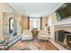 Bright living room with fireplace, stylish seating, and view to the foyer at 219 Buckingham Dr, Indianapolis, IN 46208