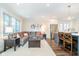 Inviting living room with a large sectional sofa, hardwood floors, and stainless steel kitchen appliances at 219 Buckingham Dr, Indianapolis, IN 46208