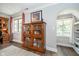 Living room with windows and a built-in bookshelf at 219 Buckingham Dr, Indianapolis, IN 46208