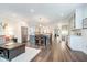 Open-concept design showcases kitchen with island seating and stainless steel appliances, flowing into a living area at 219 Buckingham Dr, Indianapolis, IN 46208
