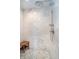 Detail of the shower with marble tile and rain shower head at 219 Buckingham Dr, Indianapolis, IN 46208