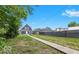 Large backyard with a walkway leading to the house and garage, offering ample space at 2257 E Brookside Ave, Indianapolis, IN 46218