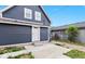 View of the backyard featuring the home's exterior, access door, and concrete patio at 2257 E Brookside Ave, Indianapolis, IN 46218