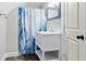 Bathroom featuring a new vanity, stylish sink, and a shower with a striking blue curtain at 2257 E Brookside Ave, Indianapolis, IN 46218