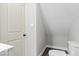 Cozy bathroom with a modern toilet and storage space under an angled ceiling at 2257 E Brookside Ave, Indianapolis, IN 46218