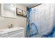 Updated bathroom with a modern vanity, stylish sink, and a shower with a unique curtain at 2257 E Brookside Ave, Indianapolis, IN 46218