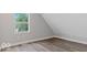 This bedroom features gray walls, wood floors, and a window with natural light at 2257 E Brookside Ave, Indianapolis, IN 46218