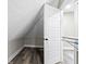 Storage area features wood floor, a rack to hang clothes, and white door at 2257 E Brookside Ave, Indianapolis, IN 46218