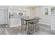 Dining area featuring stainless steel appliances, modern fixtures, and wood floors at 2257 E Brookside Ave, Indianapolis, IN 46218