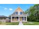 Charming two-story home with a welcoming front porch and blue siding at 2257 E Brookside Ave, Indianapolis, IN 46218