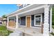 Front porch featuring stone columns, an orange door, and two windows at 2257 E Brookside Ave, Indianapolis, IN 46218