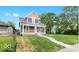 Charming two-story home with a well-manicured front lawn and inviting porch at 2257 E Brookside Ave, Indianapolis, IN 46218