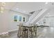 Open-concept dining area with modern lighting, adjacent to the living room and staircase at 2257 E Brookside Ave, Indianapolis, IN 46218